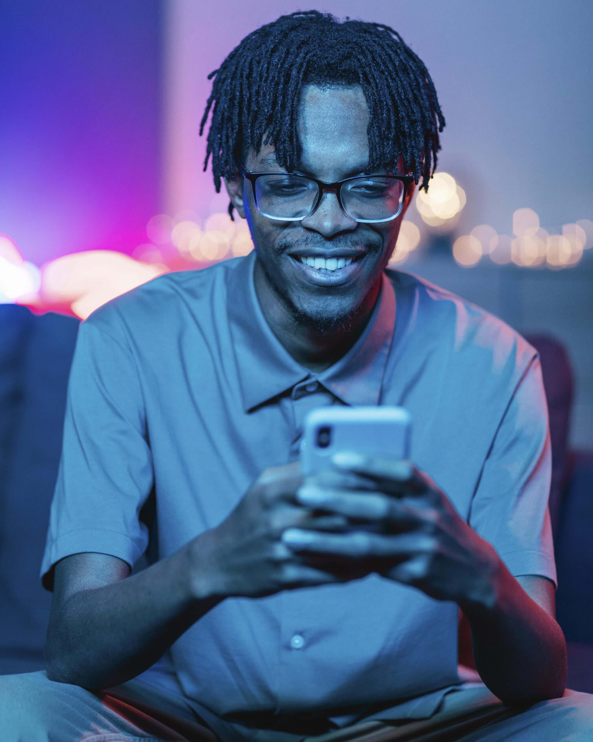 smiley-man-using-his-smartphone-while-home